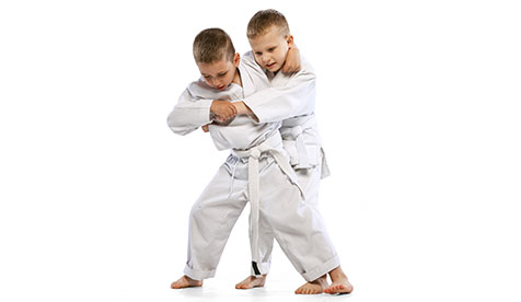 two boys training jiu jitsu